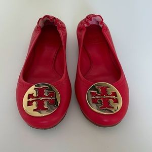 Red leather Tory Burch flats with gold logo
